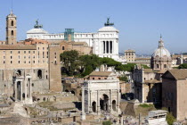 The Forum and tourists with from left to right the columns of the Temple of Saturn  the triumphal Arch of Septimius Severus  the Medieval church of Santi Luca e Martina and the Curia with the white ma...