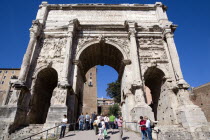 Tourists walking through the triumphal Arch of Septimius Severus from the Forum towards the CapitolEuropean Italia Italian Roma Southern Europe Gray History Holidaymakers Tourism Grey