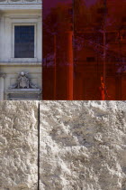 A red perspex cube part of a Valentino fashion exhibition behind a stone wall outside the Ara Pacis in front of the neo Classical church of San Rocco designed by Giuseppe ValadierEuropean Italia Ital...