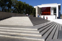 The steps with sightseers leading to the building hosuing the Ara Pacis or Altar of Peace built by Emperor Augustus to celebrate peace in the Mediteranean. The red prespex cube is part of a Valentino...