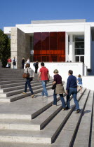 The steps with sightseers leading to the building hosuing the Ara Pacis or Altar of Peace built by Emperor Augustus to celebrate peace in the Mediteranean. The red prespex cube is part of a Valentino...