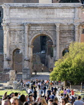 Tourists walking through the triumphal Arch of Septimius Severus from the Forum towards the CapitolEuropean Italia Italian Roma Southern Europe Gray History Holidaymakers Tourism Grey