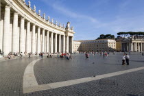 Vatican City Tourists in St Peters Square beside the curving colonnade by BerniniEuropean Italia Italian Roma Southern Europe Catholic Principality Citta del Vaticano Gray Holidaymakers Papal Religio...