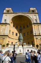 Vatican City Museum Tourists in the courtyard of the Belvedere Palace in front of the Cortile della Pigna a huge bronze pine cone from an ancient Roman fountainEuropean Italia Italian Roma Southern E...