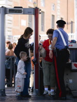 Vatican City Women with young boy at x-ray security mchine check manned by a Carabiniere policeman at an entrance to St Peters Square under the Colonnades for the Wednesday papal audience in the squar...
