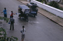 Children celebrating the lunar New Year throwing water at passing tuk tuks.Louangphrabang Asian Kids Lao Luang Prabang Southeast Asia Southern