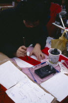 Calligraphist writing Western names in Chinese during New Year celebrations in Chinatown.calligraphy Chinese communitysociety ethnic racial diversity Asian European Great Britain Londres Northern Eu...
