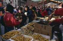 Food stall during Chinese New Year celebrations in Chinatown  Soho.  Diverse  racially mixed crowd.Chinese communitysociety Asian European Great Britain Londres Northern Europe UK United Kingdom Bri...
