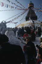 Crowd of Tibetans offering incense on the steps of the main stupa during New Year celebrations.Asia Asian Nepalese Religious Religion