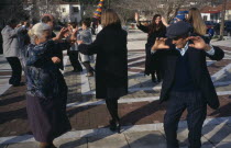 Dancing in the village square during New Year carnival.Ellada Greek Southern Europe European