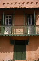 Detail of house with a green balcony  shutters and doorAfrican Senegalese
