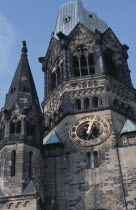 Kaiser Wilhelm Memorial Church. Part view of ruined gothic exterior with clock face.  The original church was partly destroyed during a 1943 bombing raid.Deutschland European Religion Religious Weste...