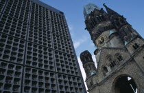 Kaiser Wilhelm Memorial Church.  Part view of ruined gothic exterior with clock face beside new building.Deutschland European Religion Religious Western Europe History