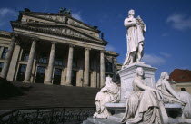The Friedrich Schiller Memorial statue by Reinhold Begas in front of the former Schauspielhaus  now Konzerthaus home of the Berlin Symphony Orchestra.sculpture poet poetry Deutschland European Wester...
