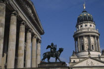 Gendarmenmarkt.  Statue of winged Bacchus riding a panther in front of the Konzerthaus with the Franzosischer Dom on right.sculpture French Cathedral Calvinst Huguenot Deutschland European Religion R...