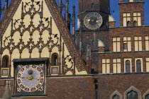 Wroclaw Town Hall dating from the fourteenth century.  Part view of exterior with decorative gable  brickwork and astronomical clock with clock tower behind. Ratusz 14th c. Eastern Europe European Hi...