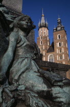 Detail of female figure on monument to the Polish romantic poet  Adam Mickiewicz by Teodor Rygier 1898 in the Old Town Square with St Mary s Church behind.literature 19th c  Nineteenth Century Cracow...