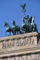 The Brandenburg Gate.  Angled view of the Quadriga on top of the gate.  Chariot drawn by four horses driven by Victoria  Roman goddess of victory.4 Deutschland Equestrian European Religion Religion R...