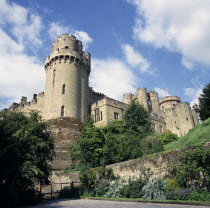 Warwick Castle from Mill Street.  Original castle built by William the Conqueror in 1068 and rebuilt in stone in the 12th c.  Crenellated walls and towers.medieval 11th c. eleventh century twelth cen...
