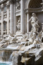 The 1762 Trevi Fountain by Nicola Salvi with a statue of the god Neptune on the right and tritons in the foreground representing the moods of the seaEuropean Italia Italian Roma Southern Europe Gray...