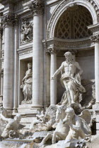 The 1762 Trevi Fountain by Nicola Salvi with a statue of the god Neptune on the right and tritons in the foreground representing the moods of the seaEuropean Italia Italian Roma Southern Europe Gray...
