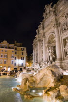 The 1762 Trevi Fountain by Nicola Salvi illuminated at night with tourists in the Piazza Di TreviEuropean Italia Italian Roma Southern Europe History Holidaymakers Nite Tourism