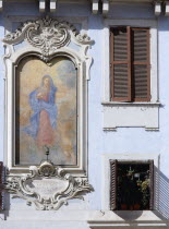 Religious fresco on the wall of a building in the Piazza Della Rotonda beside windows with shuttersEuropean Italia Italian Roma Southern Europe Religion