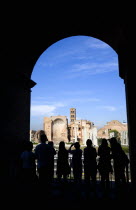 Silhouette of tourists on a balcony of the Colosseum looking out towards the Temple of Venus and Rome in the ForumEuropean Italia Italian Roma Southern Europe History Holidaymakers Religion Tourism