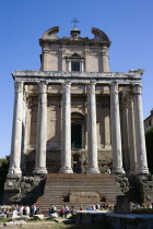 Tourists walking past the Temple of Antoninus and Faustina incorporated into the church of San Lorenzo in Miranda in the ForumEuropean Italia Italian Roma Southern Europe History Holidaymakers Religi...