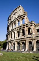 The Colosseum amphitheatre exterior with tourists walking past built by Emperor Vespasian in AD 80 in the grounds of Domus Aurea the home of Emperor NeroEuropean Italia Italian Roma Southern Europe H...