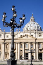 Vatican City The Basilica of St Peter with tourists at the entrance and an ornate lamppost the Piazza San PietroEuropean Italia Italian Roma Southern Europe Catholic Principality Citta del Vaticano H...