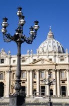 Vatican City The Basilica of St Peter with tourists at the entrance and an ornate lamppost the Piazza San PietroEuropean Italia Italian Roma Southern Europe Catholic Principality Citta del Vaticano H...