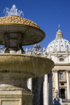 Vatican City The Basilica of St Peter and the square or Piazza San Pietro with a water fountain in the foregroundEuropean Italia Italian Roma Southern Europe Catholic Principality Citta del Vaticano...
