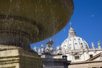 Vatican City The Basilica of St Peter and the square or Piazza San Pietro with a water fountain in the foregroundEuropean Italia Italian Roma Southern Europe Catholic Principality Citta del Vaticano...