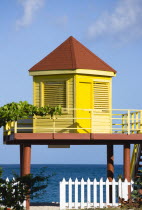 Grand Anse Beach with bright yellow lifeguard post on stilts overlooking the sea with a white picket fence in the foregroundBeaches Resort Sand Sandy Scenic Seaside Shore Tourism West Indies Caribbea...