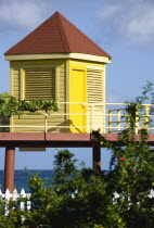 Grand Anse Beach with bright yellow lifeguard post on stilts overlooking the sea with a white picket fence in the foregroundBeaches Resort Sand Sandy Scenic Seaside Shore Tourism West Indies Caribbea...