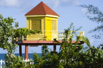 Grand Anse Beach with bright yellow lifeguard post on stilts overlooking the sea with a white picket fence in the foregroundBeaches Resort Sand Sandy Scenic Seaside Shore Tourism West Indies Caribbea...