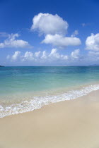 Gentle waves breaking on the shoreline of Paradise Beach in L Esterre Bay with Sandy Island sand bar on the horizonBeaches Resort Sand Sandy Scenic Seaside Shore Tourism West Indies Caribbean Grenadi...