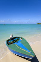 A speedboat on the beach with gentle waves breaking on the shoreline of Paradise Beach in L Esterre Bay with Sandy Island sand bar on the horizonBeaches Resort Sand Sandy Scenic Seaside Shore Tourism...