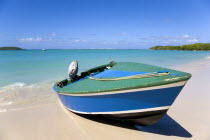 A speedboat on the beach with gentle waves breaking on the shoreline of Paradise Beach in L Esterre Bay with Sandy Island sand bar on the horizonBeaches Resort Sand Sandy Scenic Seaside Shore Tourism...