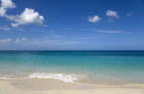 Waves breaking on the shore at Grand Anse Beach with the turquoise sea beyondBeaches Resort Sand Sandy Scenic Seaside Shore Tourism West Indies Caribbean Grenadian Greneda Beaches Resort Sand Sandy...