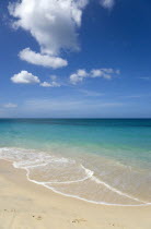 Waves breaking on the shoreline at Grand Anse beach with the turqoise sea beyondBeaches Resort Sand Sandy Scenic Seaside Shore Tourism West Indies Caribbean Grenadian Greneda Beaches Resort Sand San...