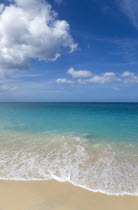 Waves breaking on the shoreline at Grand Anse beach with the turqoise sea beyondBeaches Resort Sand Sandy Scenic Seaside Shore Tourism West Indies Caribbean Grenadian Greneda Beaches Resort Sand San...