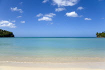 Gentle waves breaking on Morne Rouge beach known locally as BBC Beach with the opening of the bay in the turqoise sea beyondBeaches Resort Sand Sandy Scenic Seaside Shore Tourism West Indies Caribbea...