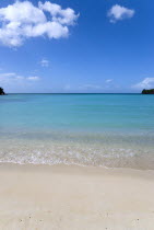 Gentle waves breaking on Morne Rouge Beach known locally as BBC Beach with the opening of the bay in the turqoise sea beyondBeaches Resort Sand Sandy Scenic Seaside Shore Tourism West Indies Caribbea...