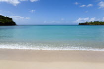 Gentle waves breaking on Morne Rouge Beach known locally as BBC Beach with the opening of the bay in the turqoise sea beyondBeaches Resort Sand Sandy Scenic Seaside Shore Tourism West Indies Caribbea...