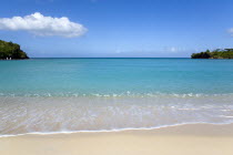 Gentle waves breaking on Morne Rouge Beach known locally as BBC Beach with the opening of the bay in the turqoise sea beyondBeaches Resort Sand Sandy Scenic Seaside Shore Tourism West Indies Caribbea...