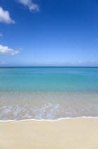 Gentle waves breaking on Morne Rouge Beach known locally as BBC Beach with the turqoise sea beyondBeaches Resort Sand Sandy Scenic Seaside Shore Tourism West Indies Caribbean Grenadian Greneda Beach...