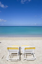 Two sunbeds on the sand with gentle waves breaking on Morne Rouge Beach known locally as BBC Beach with the turqoise sea beyondBeaches Resort Sand Sandy Scenic Seaside Shore Tourism West Indies 2 Car...