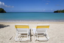 Two sunbeds on the sand with gentle waves breaking on Morne Rouge Beach known locally as BBC Beach with the turqoise sea beyondBeaches Resort Sand Sandy Scenic Seaside Shore Tourism West Indies 2 Car...